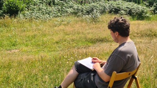 Artist sketching a view in summer